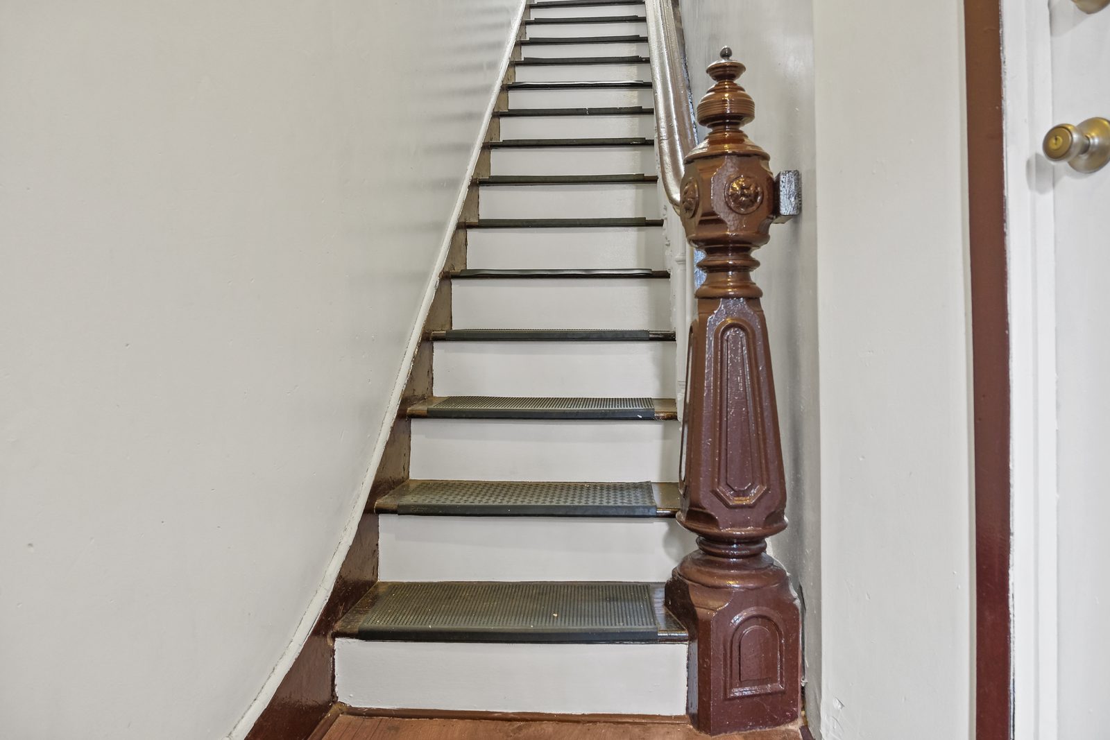 Original carved newel post and staircase at 420 Quincy Street
