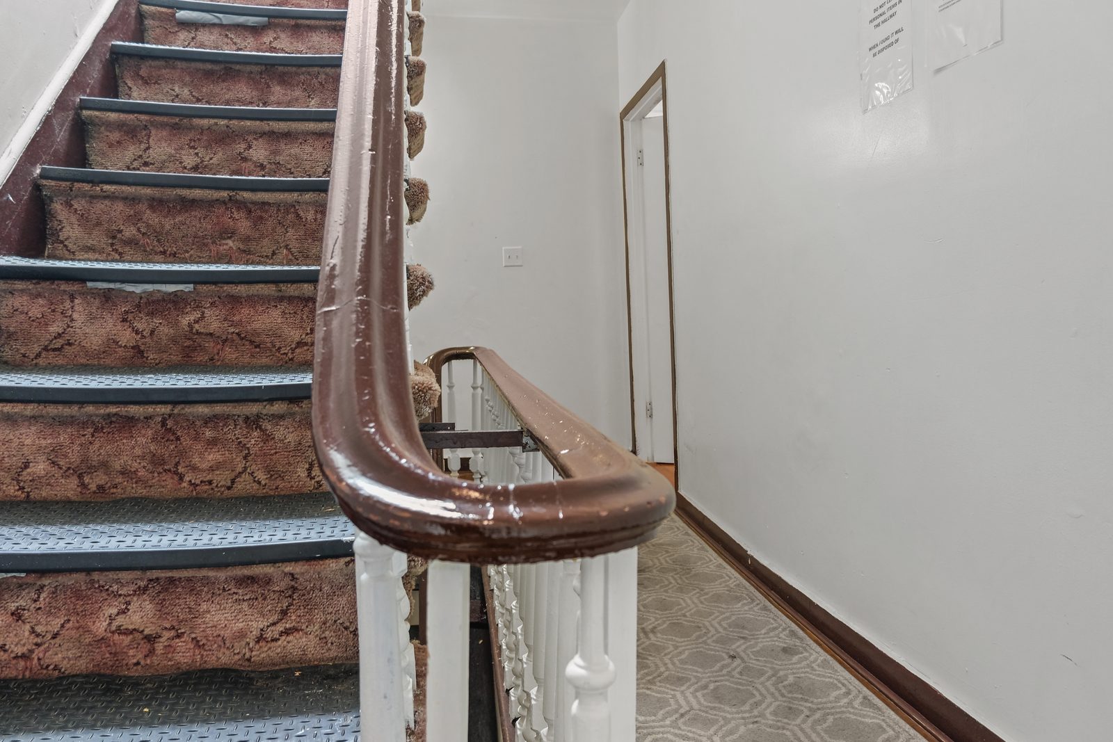 Original curved wood banister and stair hall at 420 Quincy Street